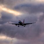 Surviving an Airplane Crash: The Air Protocol low-angle-shot-airplane-descending-from-clouded-sky_181624-26225